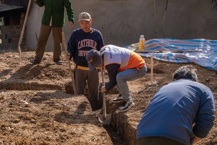 Crew digging a trench in open ground