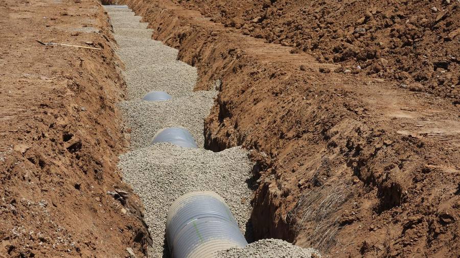 Drainage pipe being installed in an open trench